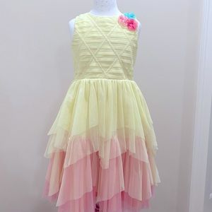 A yellow fade to pink dress, with flower at the corners, very good condition.